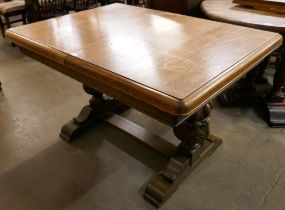 A carved oak extending dining table