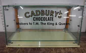 A display cabinet bearing Cadbury's inscription
