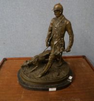 A bronze figure of huntsman and hound, on black marble socle