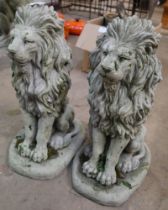 A pair of concrete figures of seated lions