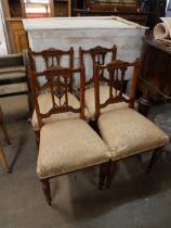 A set of four Edward VII carved walnut dining chairs