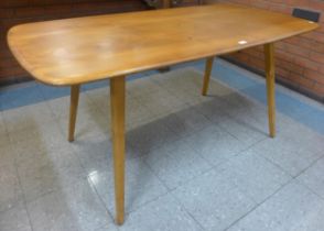 An Ercol Blonde elm and beech plank top Windsor dining table