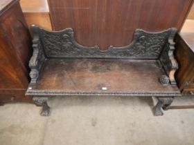 A Victorian Jacobean Revival carved oak window seat