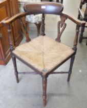 An Arts and Crafts style oak corner chair