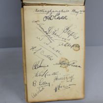 A cricket autograph book, filled with signatures including Don Bradman, Harold Larwood, Gunn,