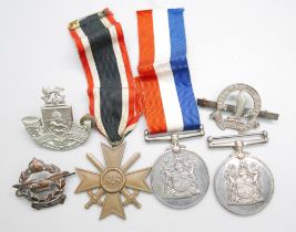 Two South African For War Services Medals, a German Cross medal and three badges