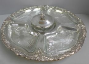 A large silver plated hors d'oeuvres dish with cenral lidded preserve pot and four glass sections