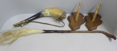 A pair of mounted stag horns, a horn powder flask and a fly swat