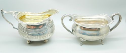 A 19th Century silver cream jug and an early 20th Century silver sugar bowl, worn Birmingham and