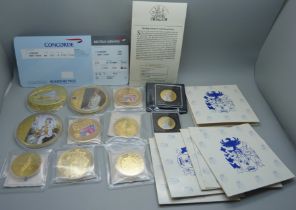 A collection of gold plated commemorative coins and medallions including Concorde with