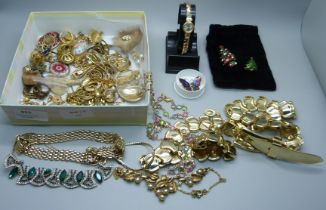 A collection of gold toned jewellery including a Dior brooch, a 9ct gold wristwatch and two Butler