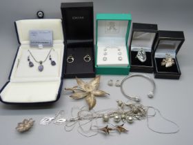 A collection of silver and white metal jewellery, some boxed