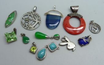 Eleven silver and silver mounted pendants and a plated 'Playboy' pendant