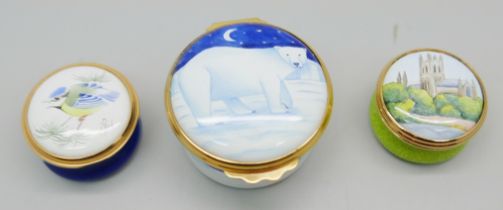 Two Moorcroft enamelled pill boxes, one signed, and one other enamelled pill box