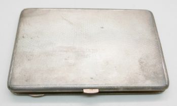 A silver cigarette case with a hallmarked 9ct gold release button and gilt interior, London 1931,