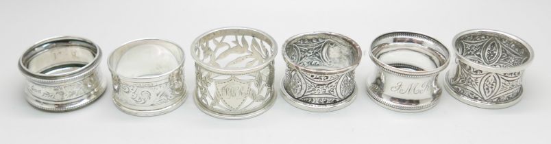 A pair of silver napkin rings, Chester 1911, and four others, 100g