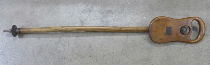 An early 20th Century wooden shooting stick with carved shooting emblem in the seat