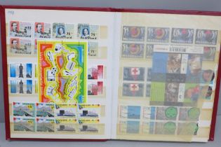 Stamps; a stock book of mint Netherlands stamps, often in blocks of four, catalogues