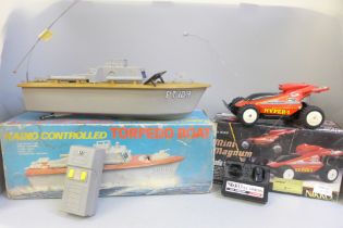 A radio controlled torpedo boat and a radio controlled Mini Magnum by Nikko, both boxed