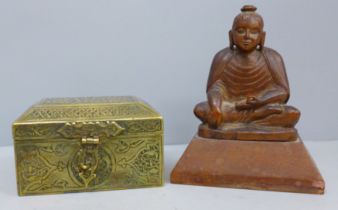 An Asian brass box and a carved wooden model of a seated Buddha