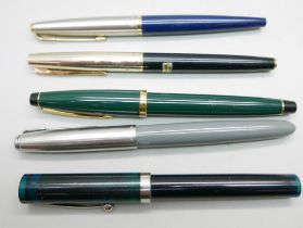 A Japanese Space Man fountain pen, two Parker, a Sheaffer with translucent cap and a Cross