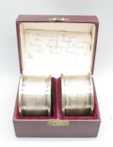 A boxed pair of silver napkin rings, 27g