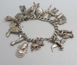 A sterling silver charm bracelet with twenty charms, 66.8g