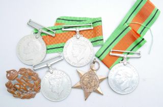 Five WWII medals and a RAF badge