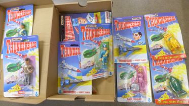 A collection of Matchbox Thunderbirds figures and rescue vehicles