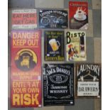 A collection of assorted tin advertising signs