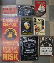 A collection of assorted tin advertising signs