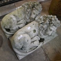 A pair of concrete garden figures of recumbent lions