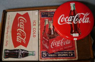 Three tin Coca-Cola advertising signs