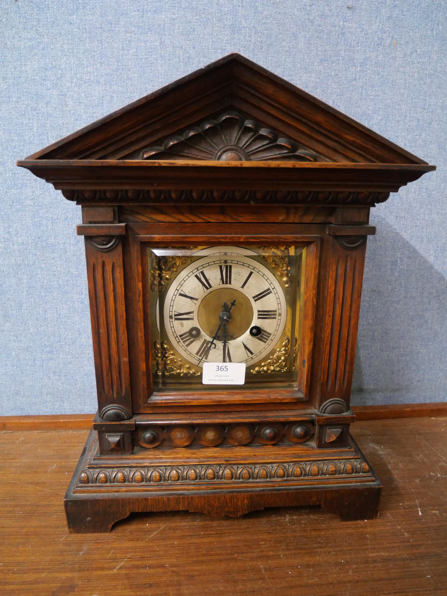 A carved oak mantle clock