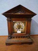 A carved oak mantle clock