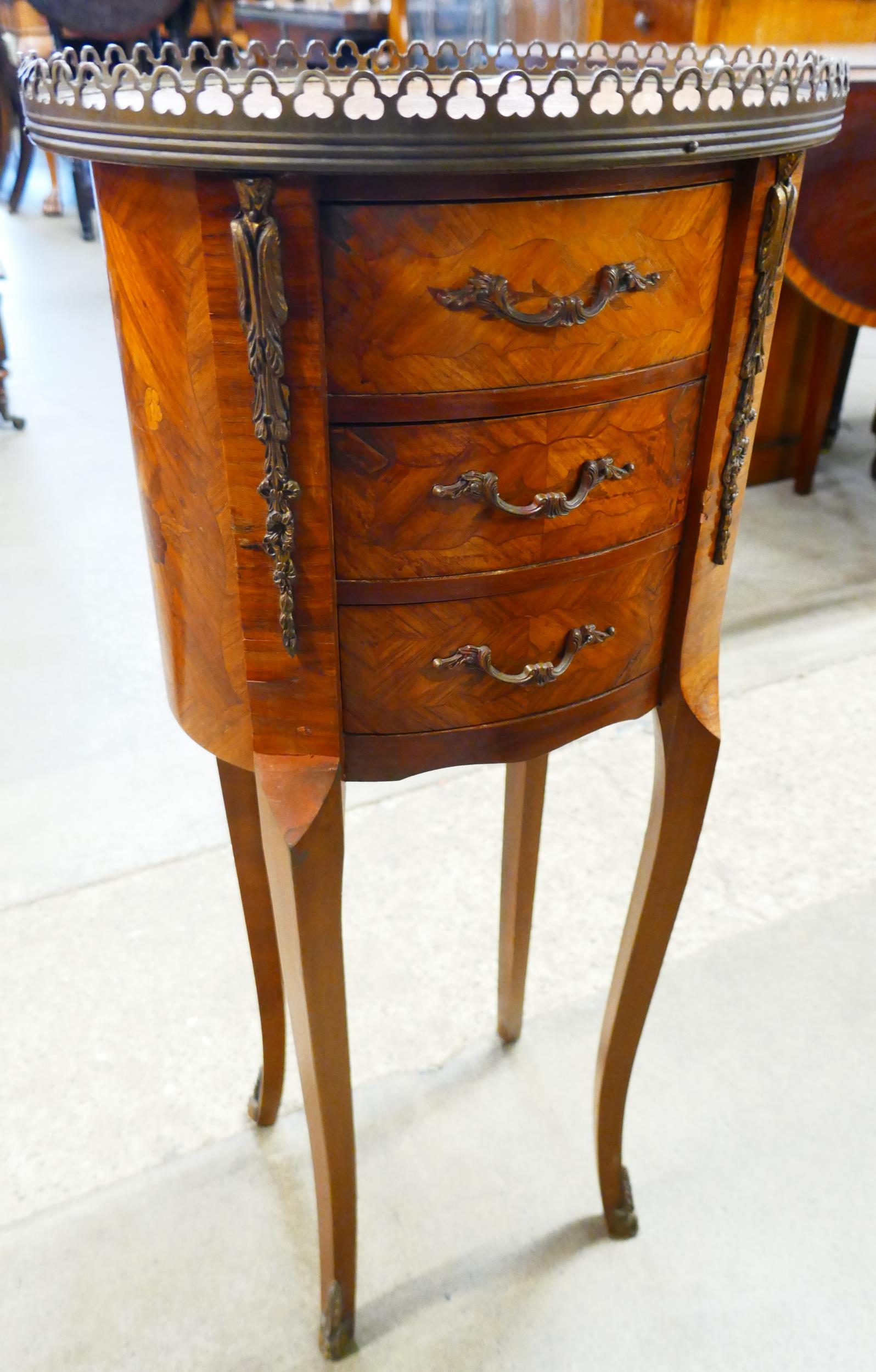 A French Louis XV style marquetry inlaid kingwood and gilt metal three drawer gueridon table