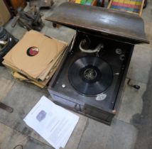 An HMV oak cased gramophone and a collection of records