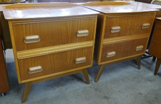 A pair of teak chests of drawers