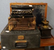 A display case, two typewriters and a coffee grinder