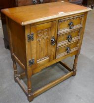 A small carved oak credence cupboard
