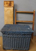 A blue painted wicker basket, an ironing board and a pine trestle