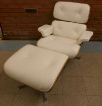 A Charles & Ray Eames style simulated rosewood and white leather revolving lounge chair and ottoman