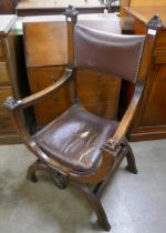 A Victorian carved oak armorial x-frame Savonarola chair