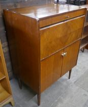 A teak and walnut cocktail cabinet