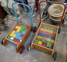 Two vintage Tri-ang baby walkers