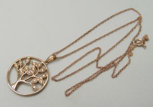A 9ct rose gold pendant with tree of life design set with fourteen small diamonds, on a 9ct rose