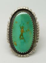 A large silver and turquoise Navajo ring, maker PJS, size P