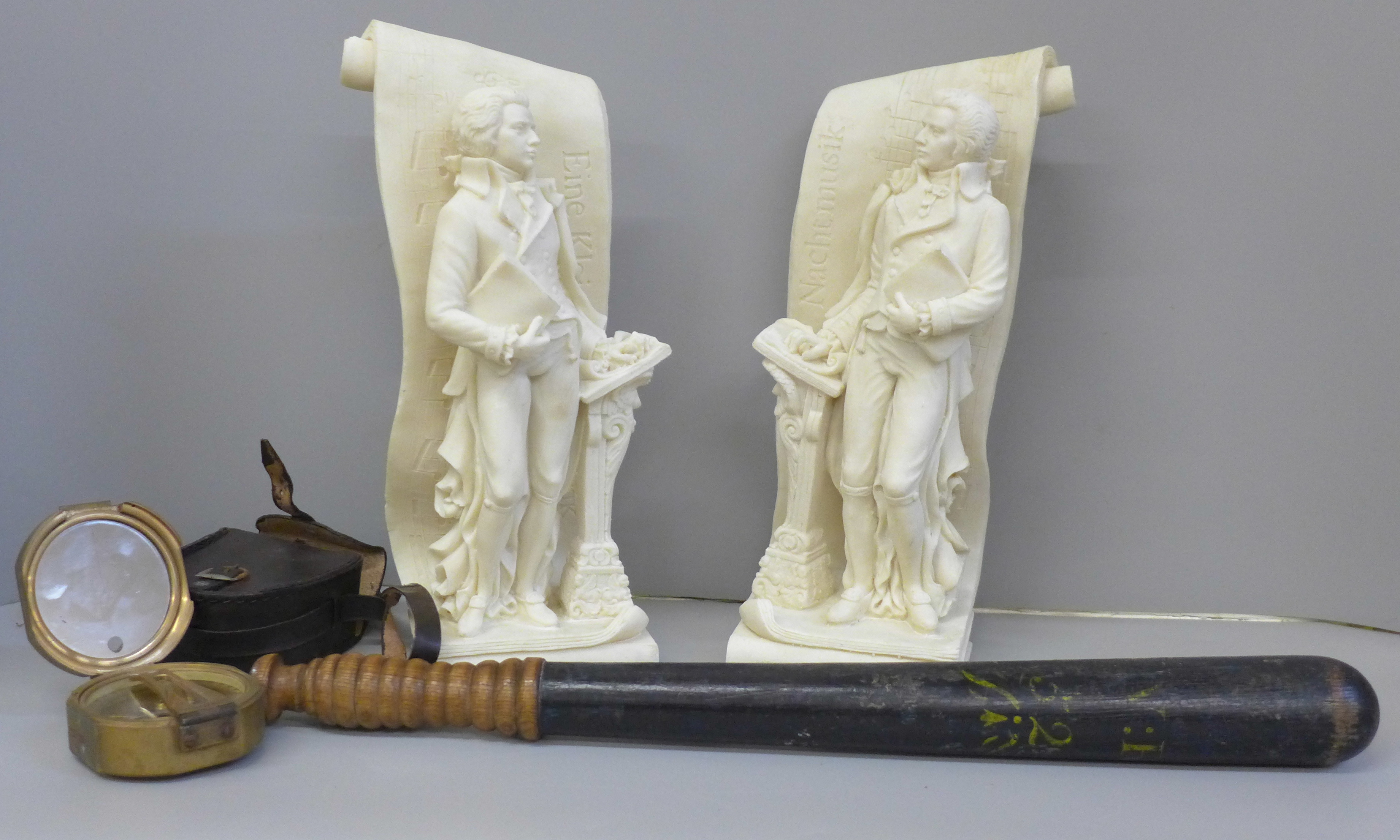 A Police truncheon, a brass compass, cased and a pair of Mozart figural bookends