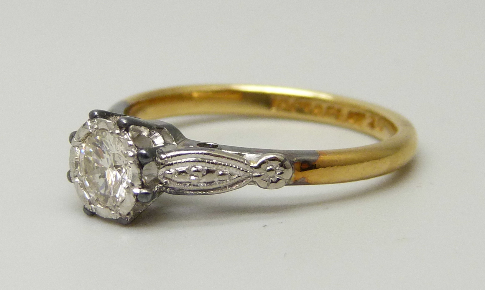 An 18ct yellow gold and platinum set round brilliant cut diamond solitaire ring, approximately 0. - Image 2 of 5