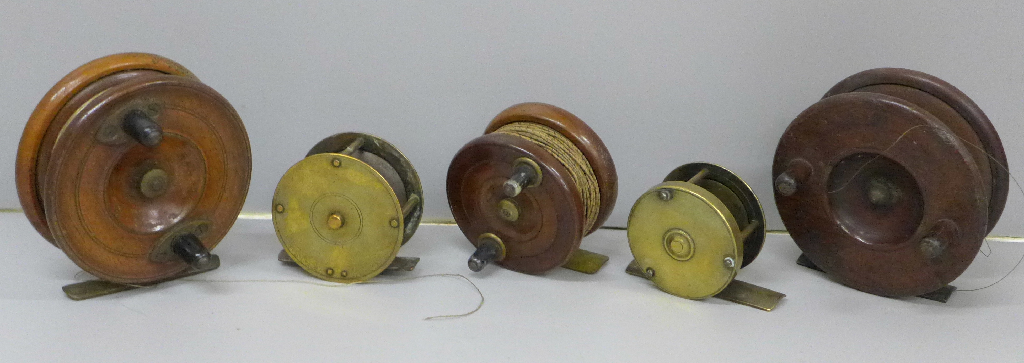 Three wooden and two brass fishing reels